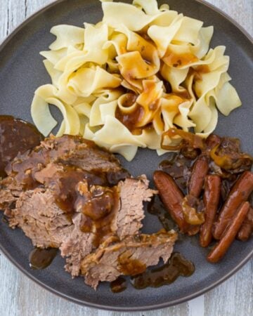 Serving Mississippi Pot Roast with carrots and mashed potatoes.